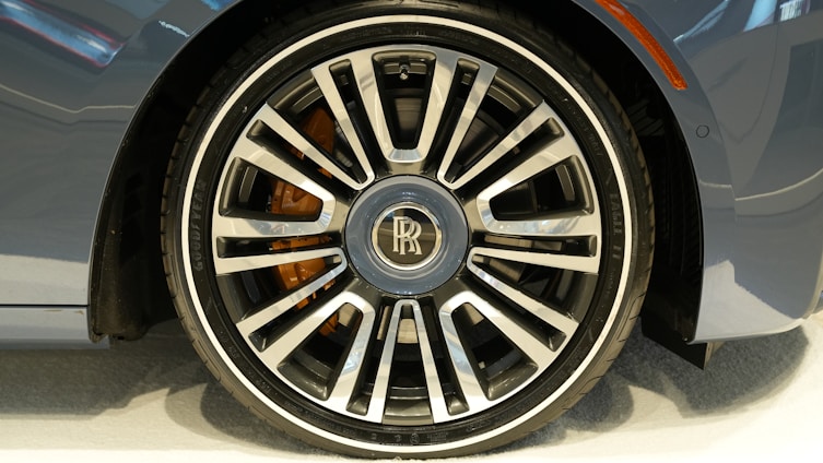 A close-up of a high-performance car wheel with a glossy finish on display.