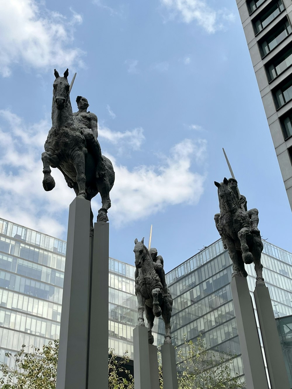 a group of statues of horses in front of a building