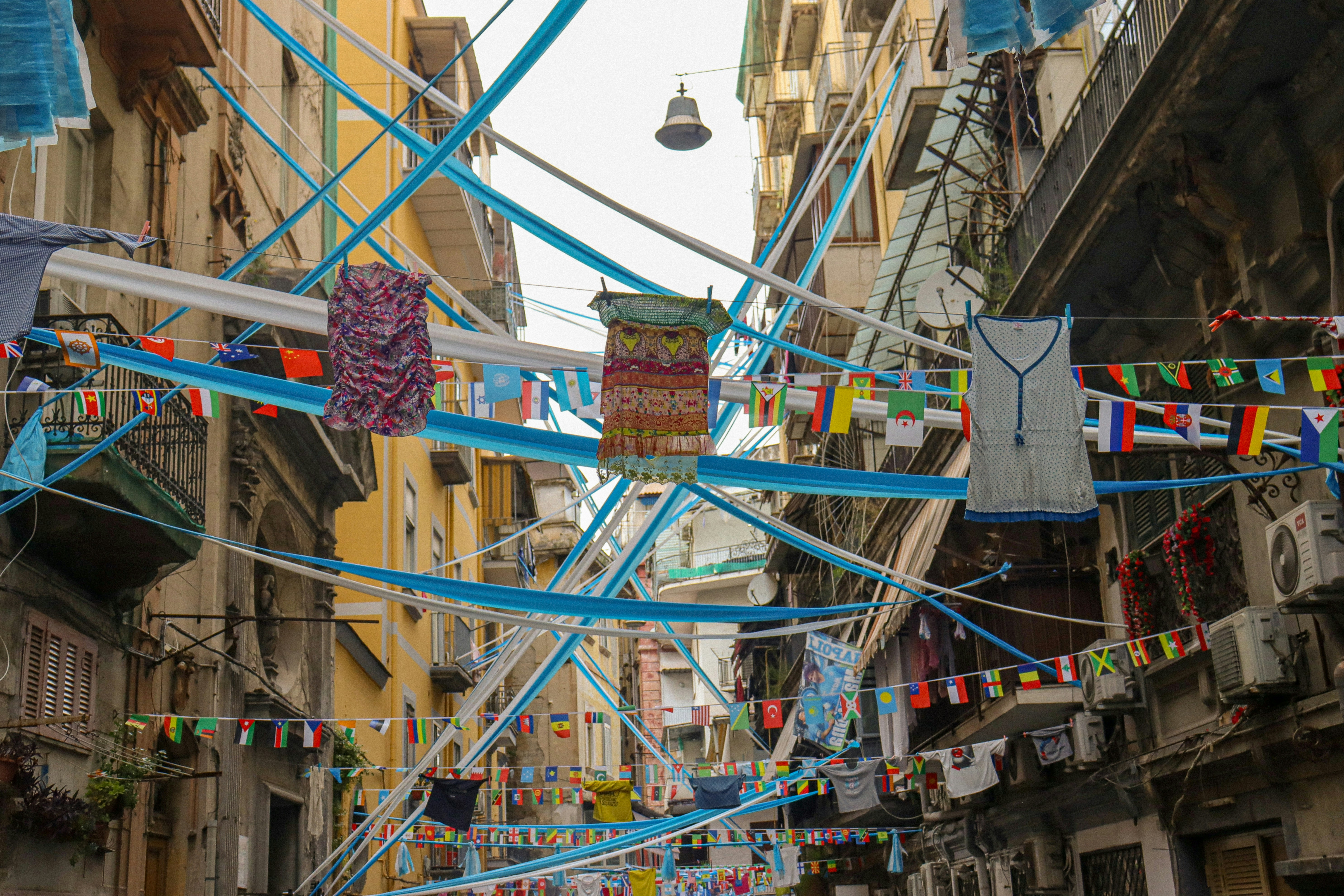 A narrow street scene in Naples with laundry hanging above