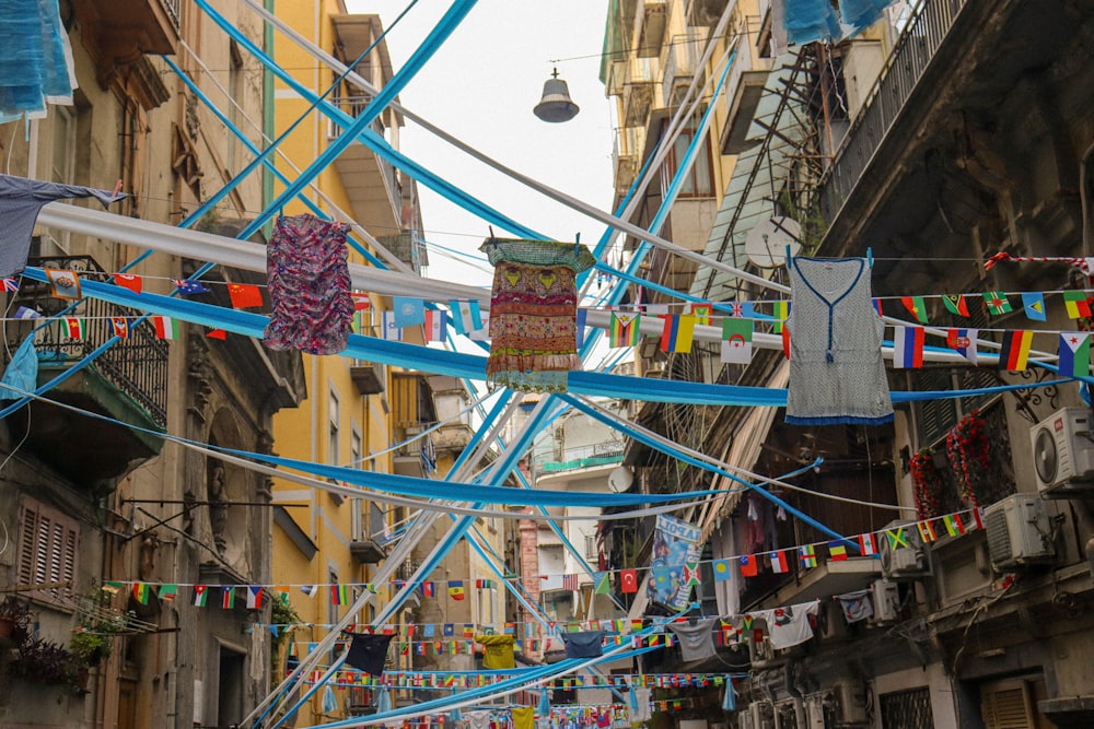 a city street filled with lots of laundry hanging from a line