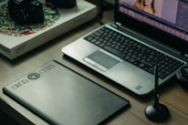 Workspace with computer and printed materials showing graphic editing work.