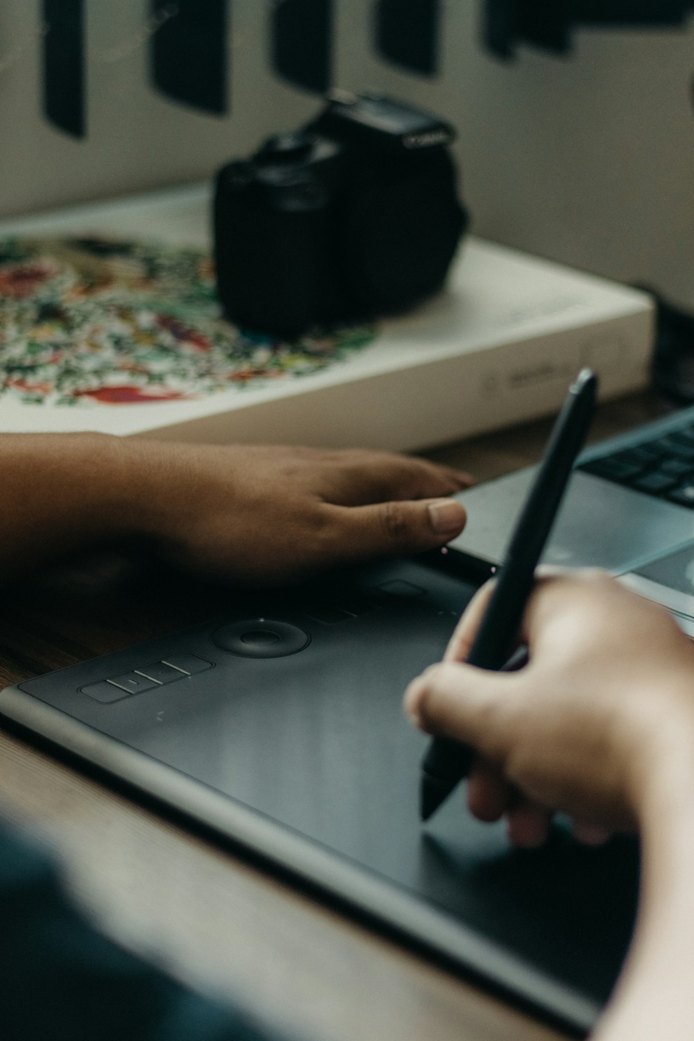 a person is writing on a notebook with a pen