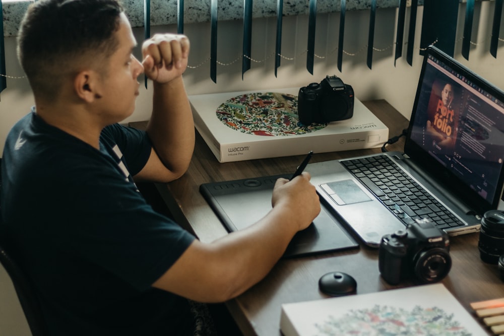 a man sitting in front of a laptop computer