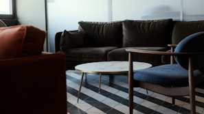 a living room filled with furniture and a checkered floor