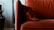 A close-up of plush pillows arranged on a stylish armchair.