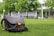 A satisfied customer showcasing their SlingAura bag in a park.