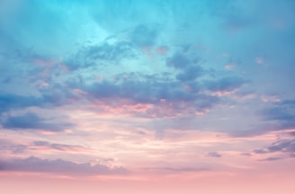 A serene lavender-hued sky with soft glowing orbs of light symbolizing angelic presence.