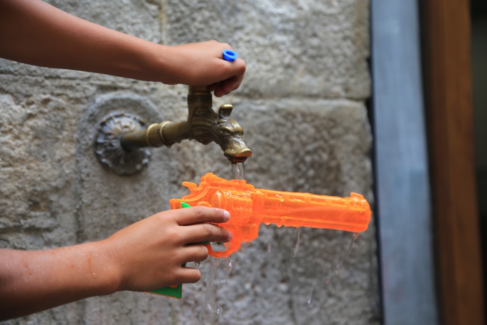 a person holding a water gun in their hand