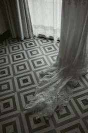 Delicate wedding accessories arranged on soft fabric with a warm glow.
