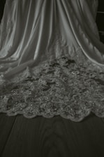 Close-up of elegant garment trims arranged artfully on a wooden table.