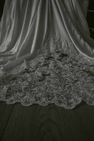 A close-up of elegant fabric textures displayed on a wooden table.