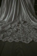 Elegant flat lay of unstitched premium fabric with delicate embroidery details.