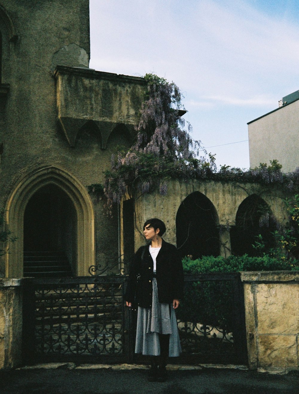 a woman standing in front of an old building