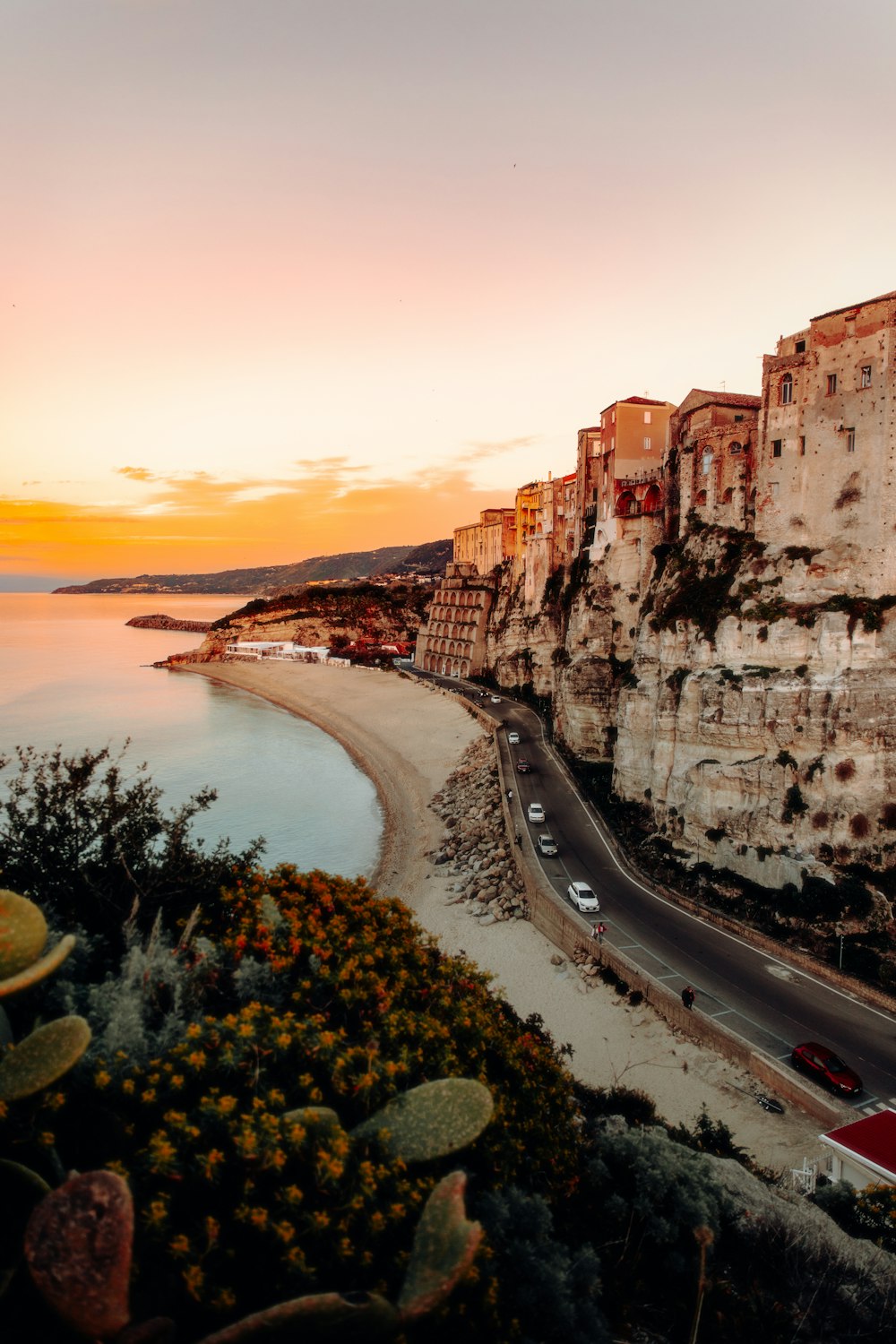 a scenic view of a beach at sunset