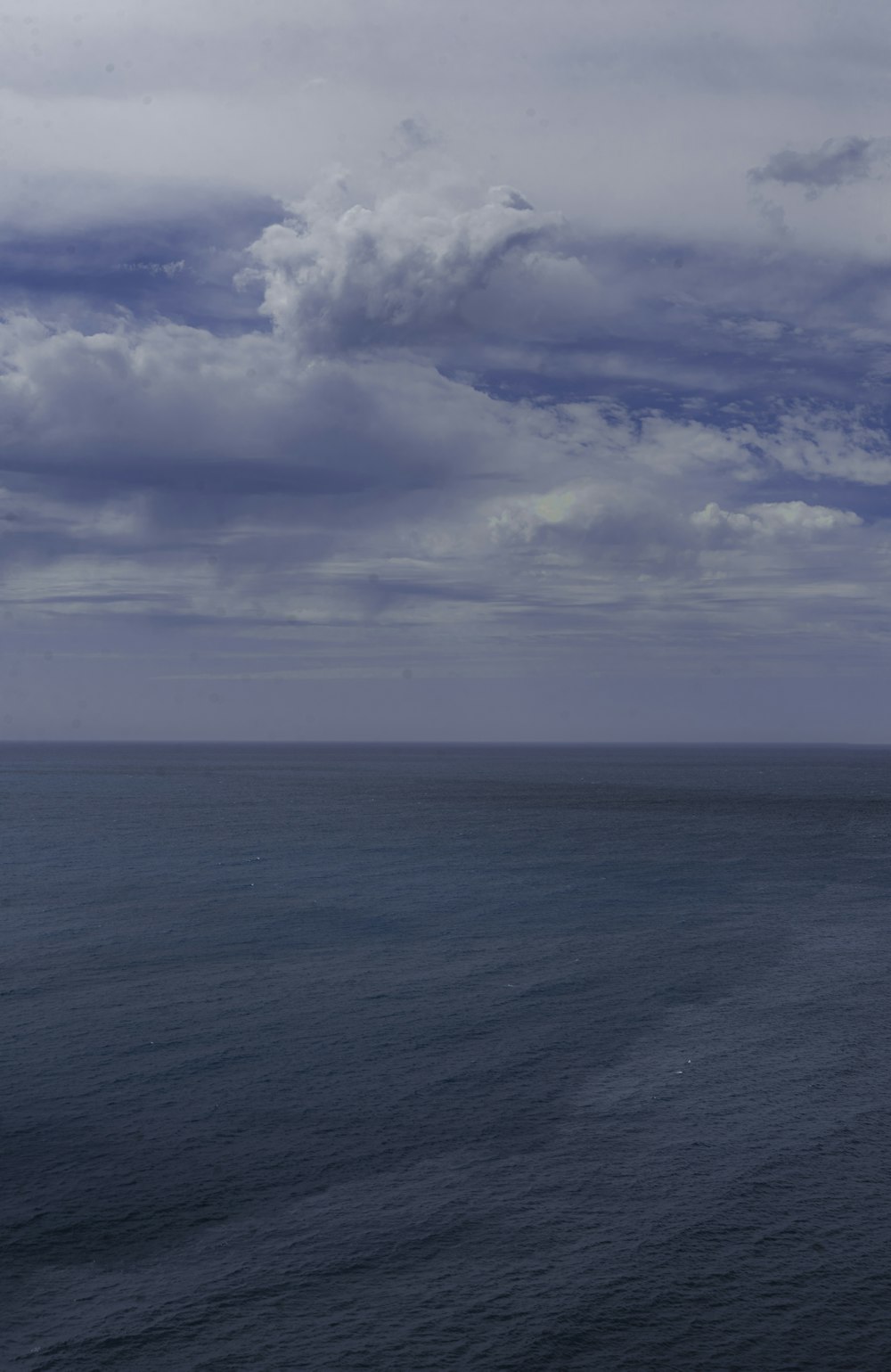 a large body of water under a cloudy sky