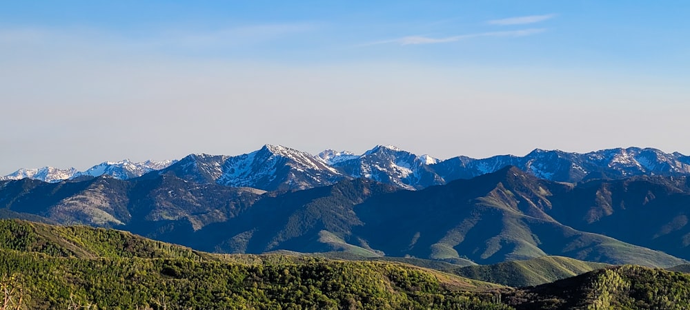 a mountain range with snow capped mountains in the distance