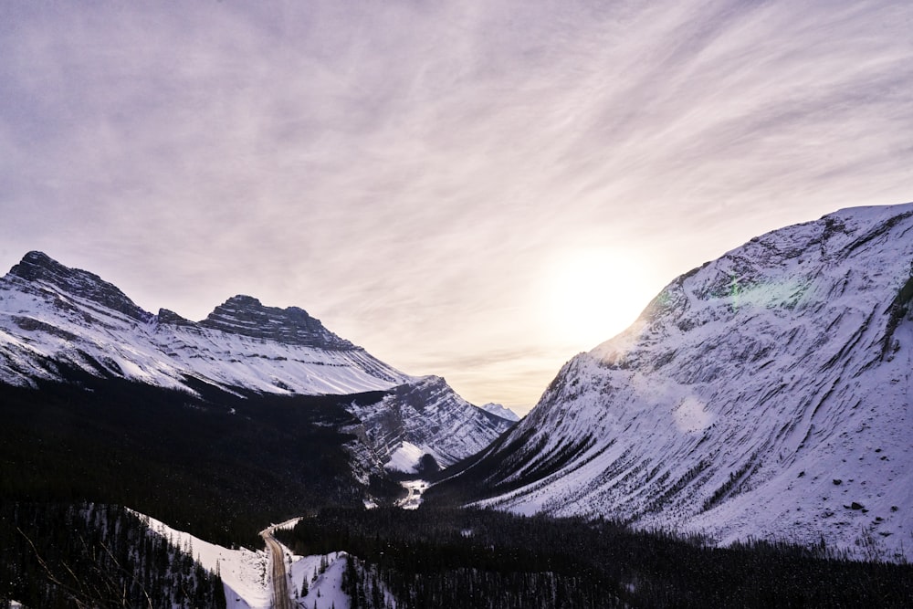 a snow covered mountain with a road going through it