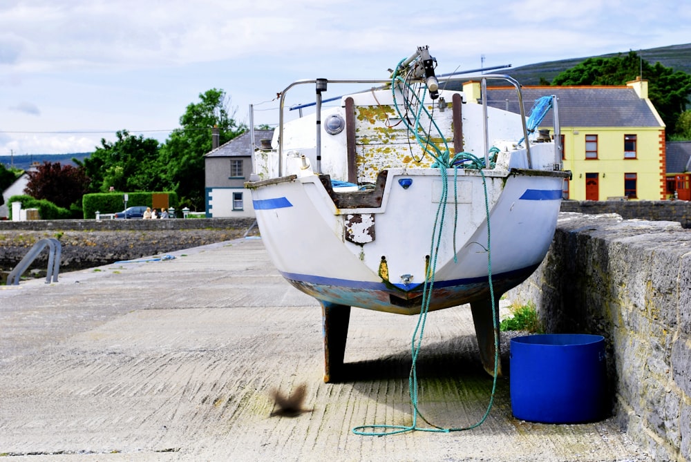 a boat sitting on top of a cement wall