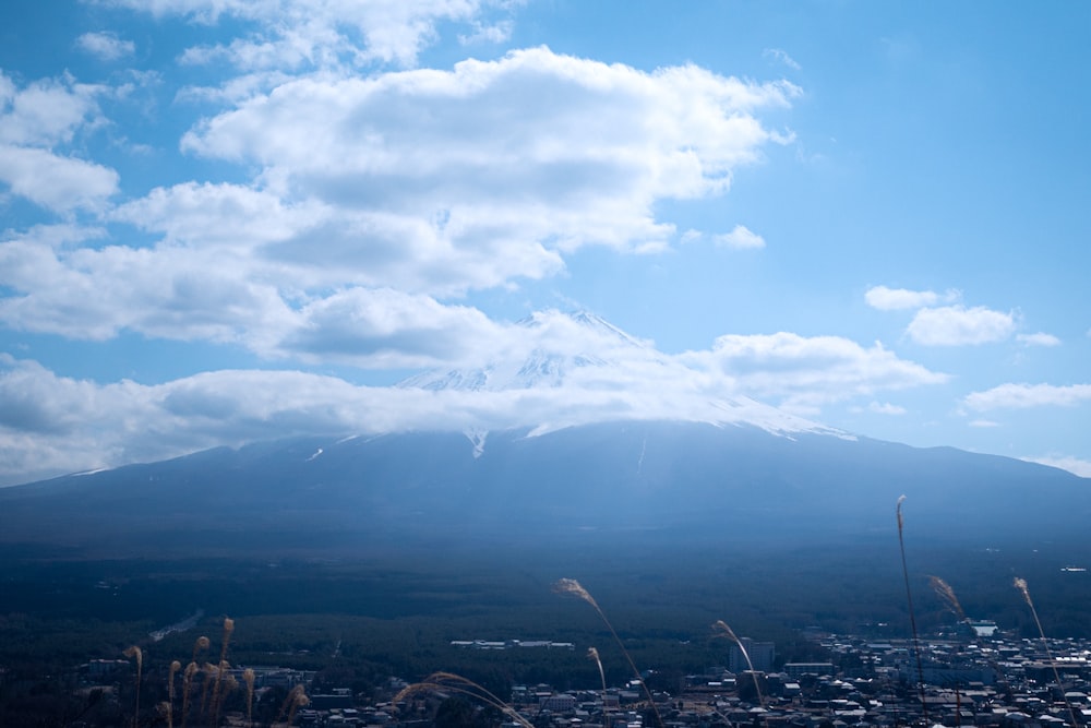 a view of a mountain with clouds in the sky