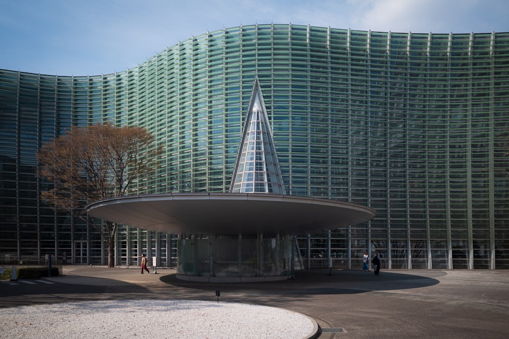 a large building with a triangular roof in front of it