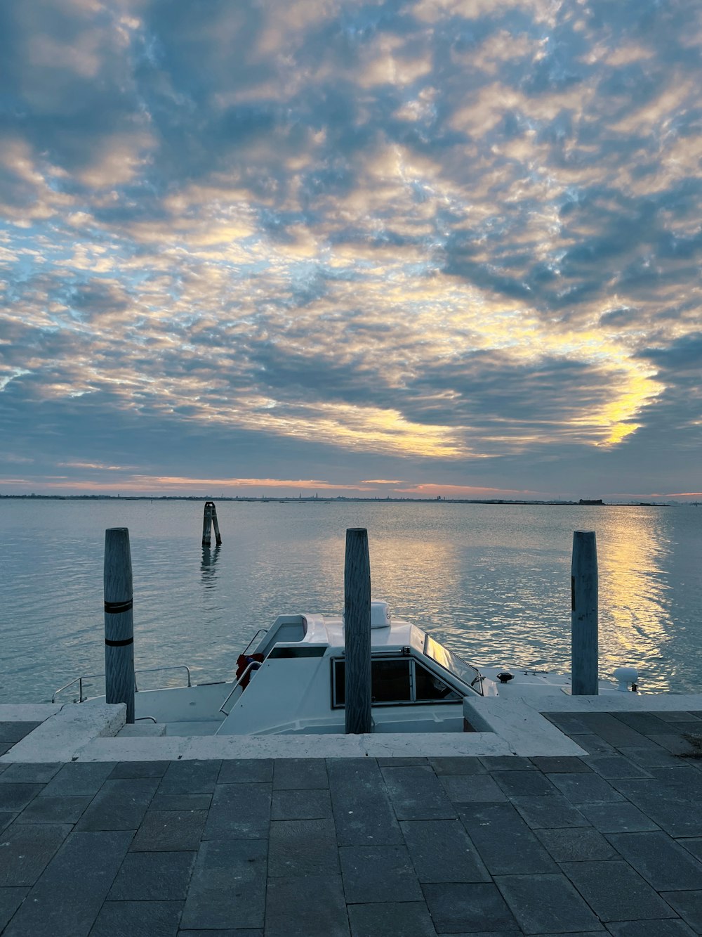 a boat is docked at the end of a pier