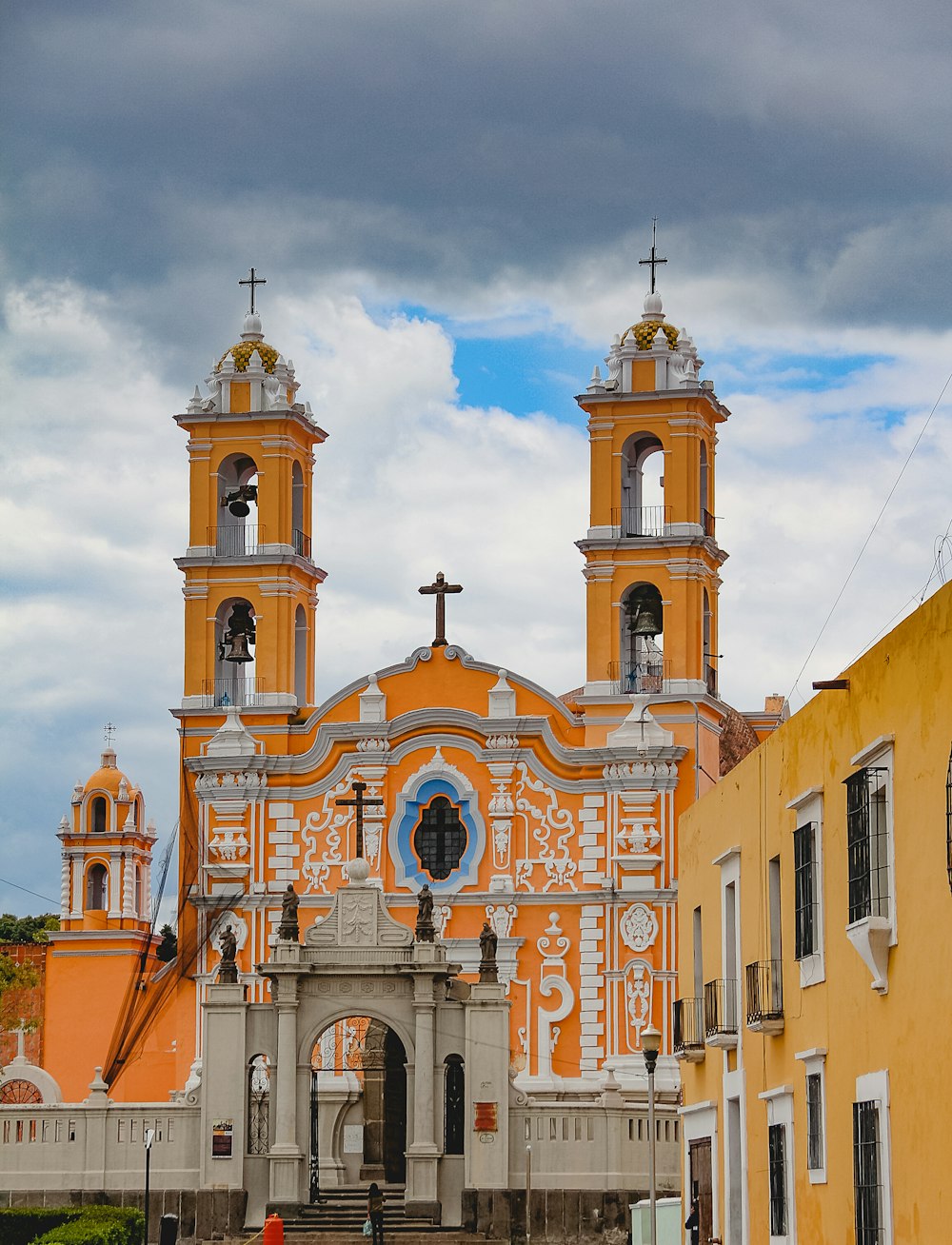 an orange and white church with two towers