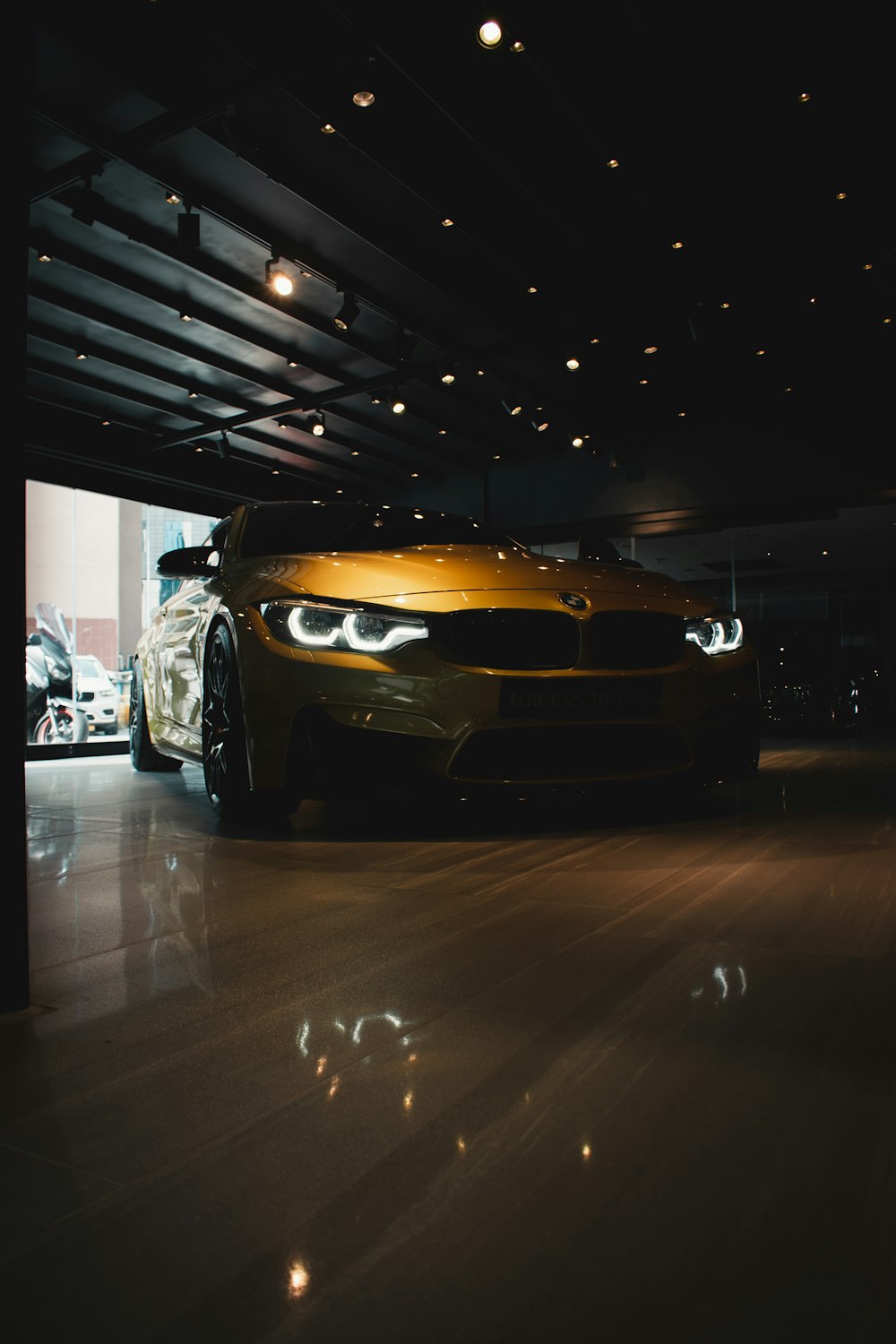 a yellow sports car parked in a garage