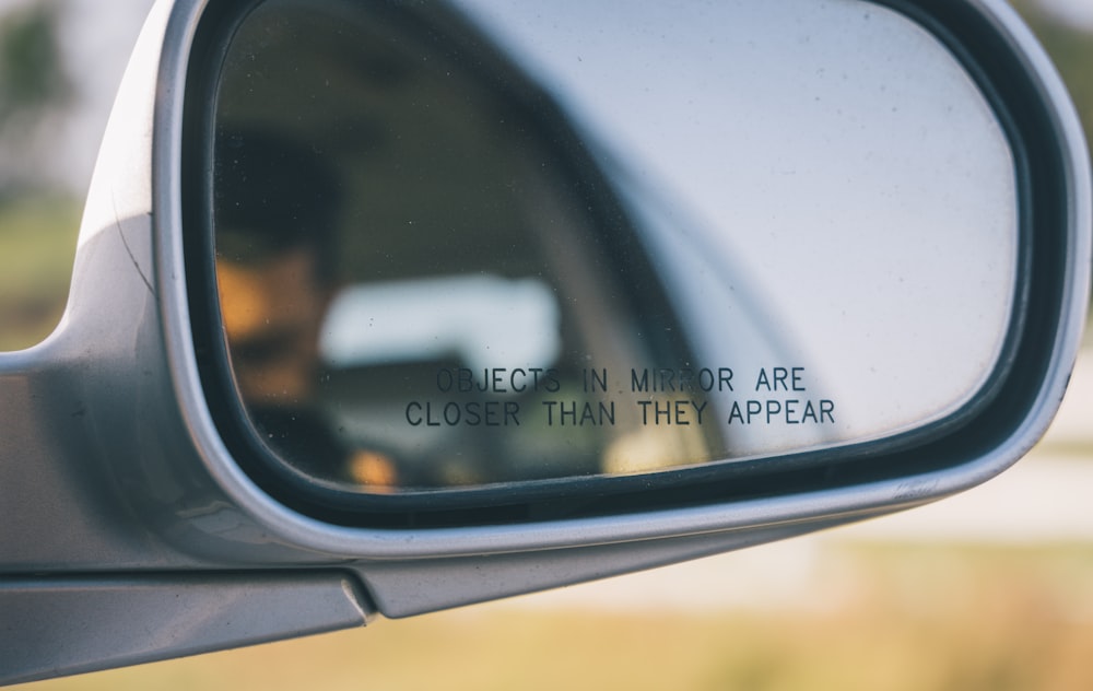 a rear view mirror with a quote on it