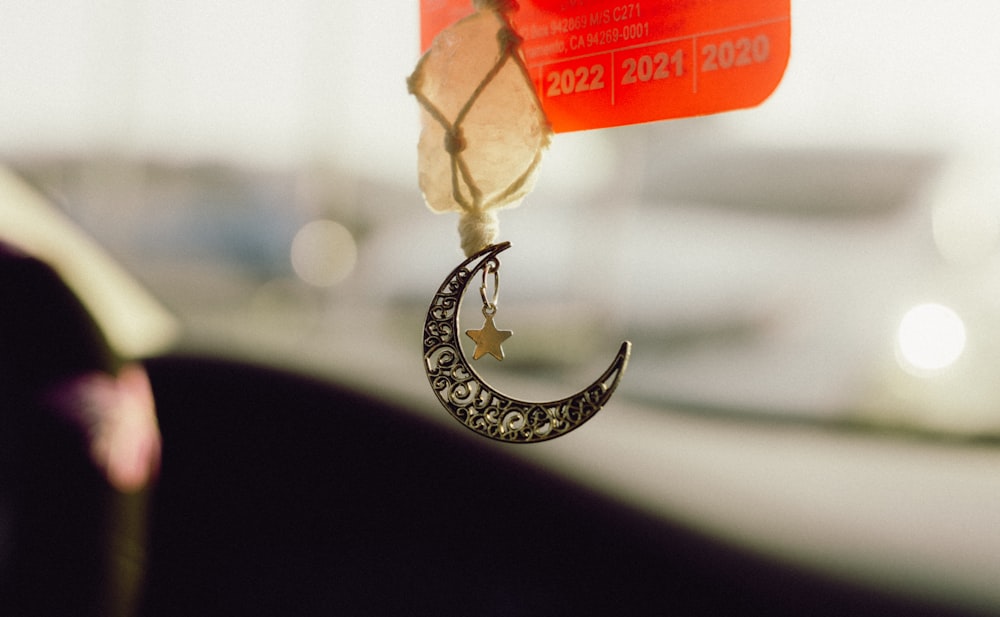 a close up of a small crescent hanging from a hook