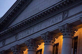 the state of utah building lit up at night