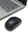 a computer mouse sitting next to a laptop