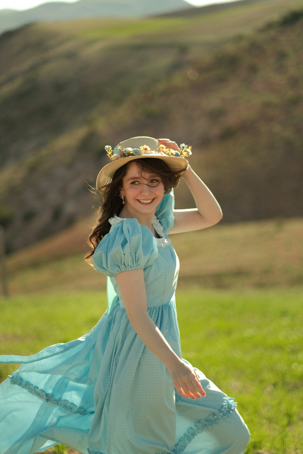 a woman in a blue dress and a hat