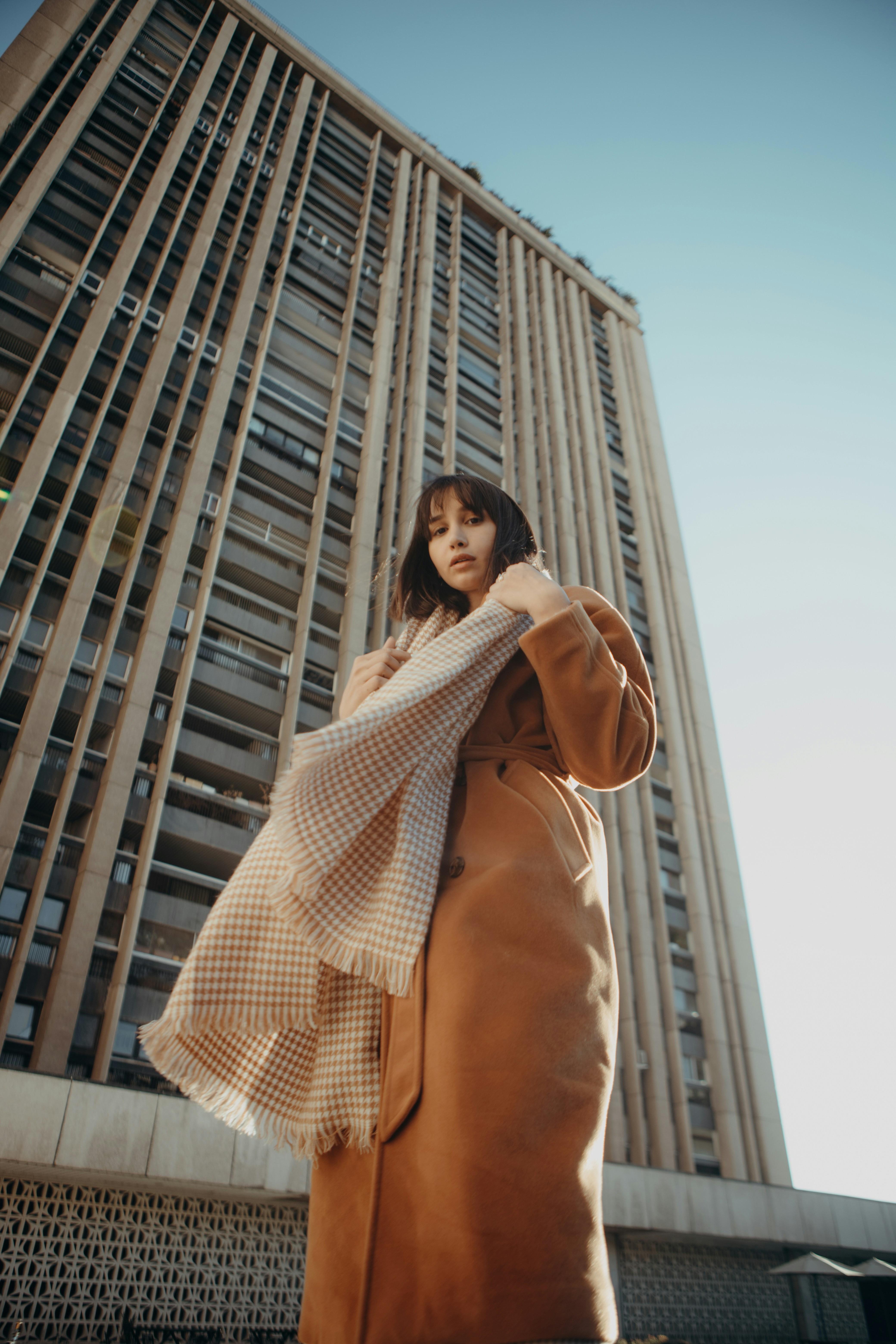 a woman standing in front of a tall building