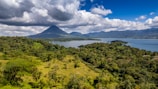 A scenic view of the Arenal volcano surrounded by greenery.