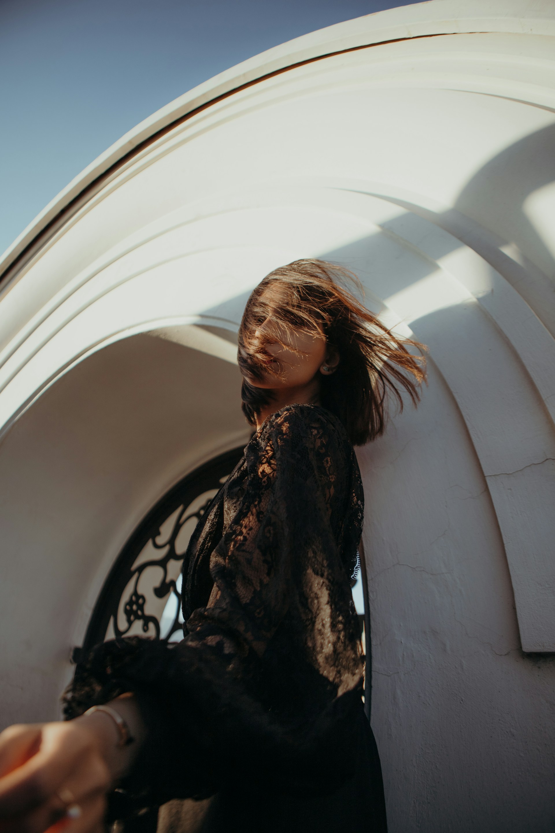 a woman standing in front of a white building