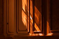 Golden hour glow illuminating the exterior sculptures, highlighting their textures and depth.