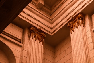A serene architectural detail of a stone column bathed in soft natural light