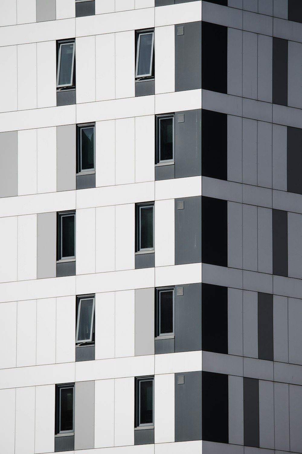 a very tall building with many windows and a clock