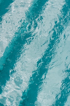 a man riding a surfboard on top of a wave