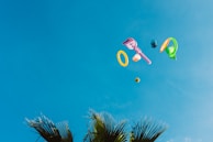 Close-up of colorful outdoor toys like jump ropes and frisbees scattered on the ground.