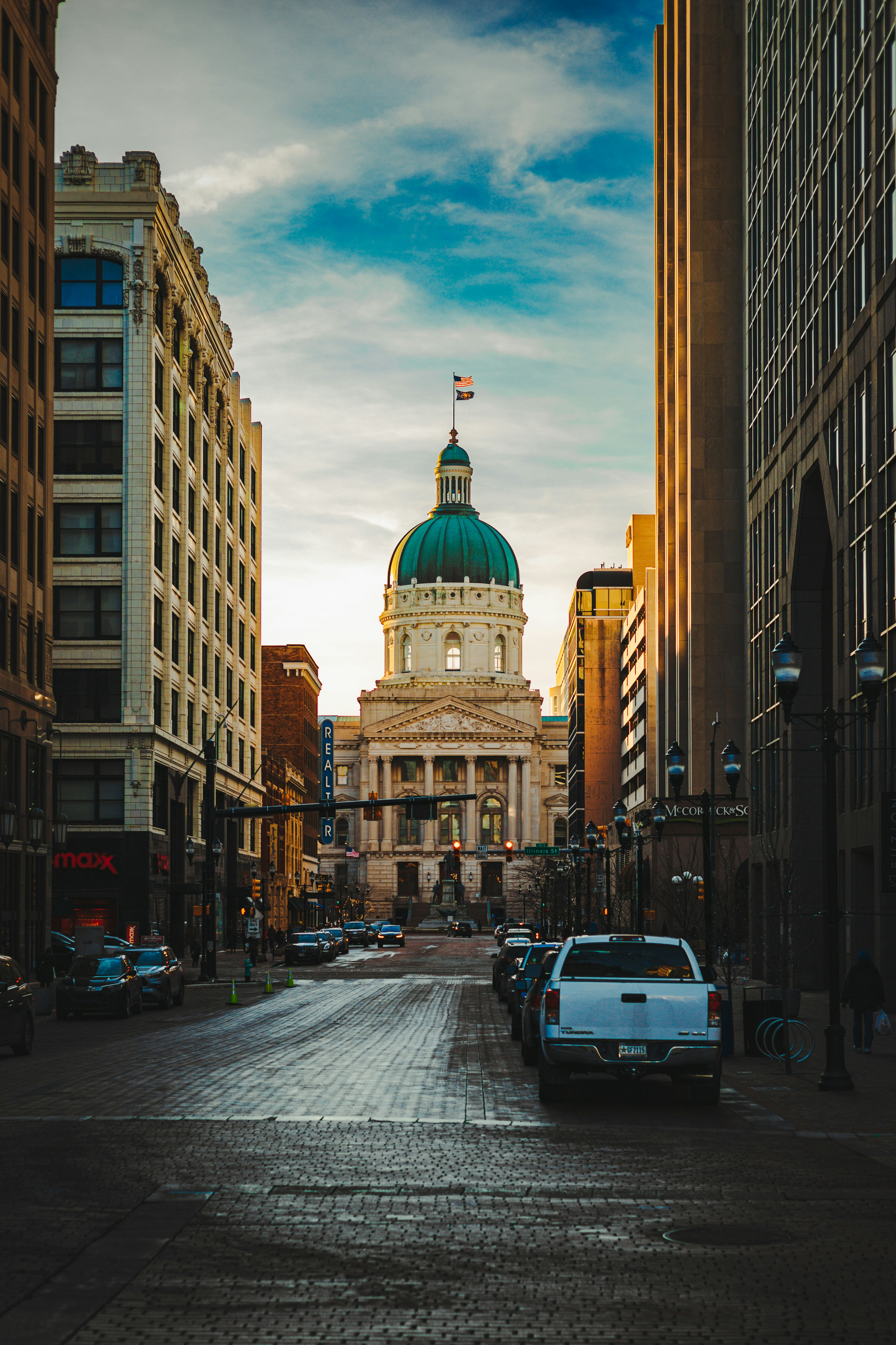 a car is parked on a cobblestone street