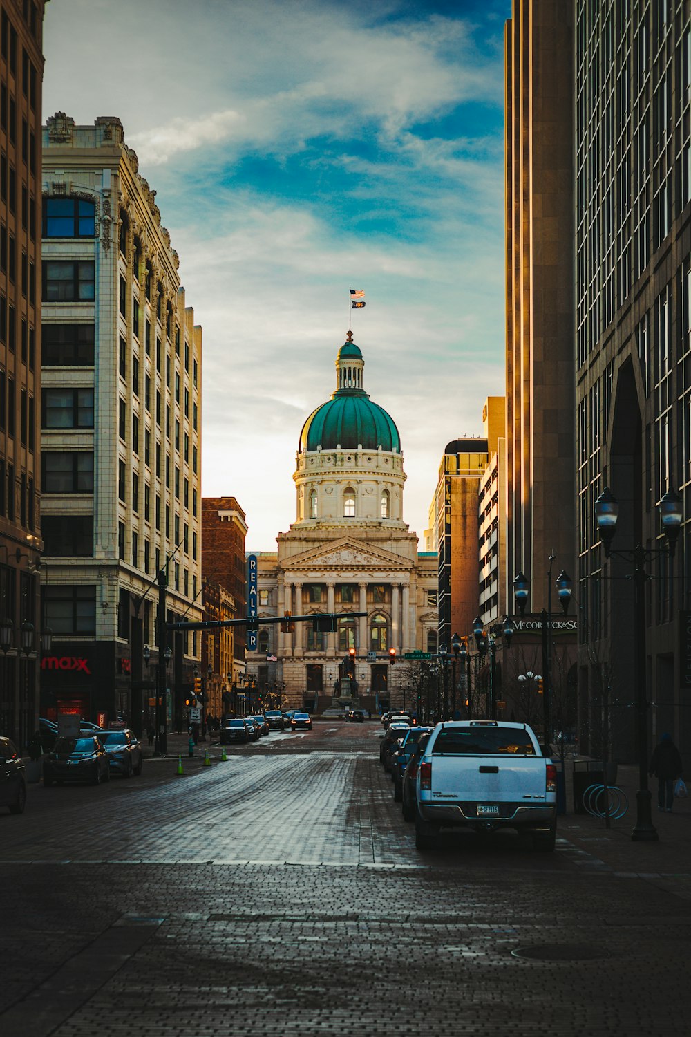 a car is parked on a cobblestone street