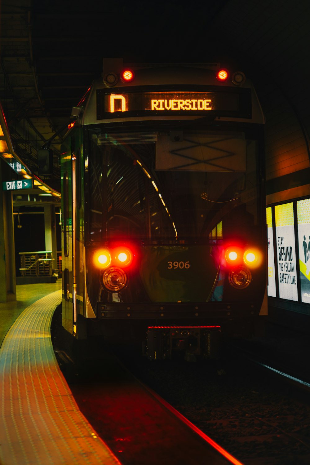 a train is pulling into a train station at night