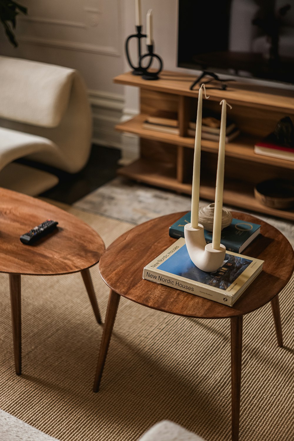 a living room with two coffee tables and a television