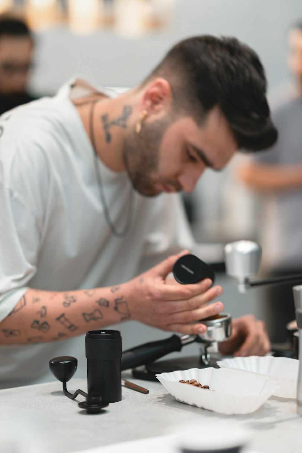a man with a tattoo on his arm working on a machine