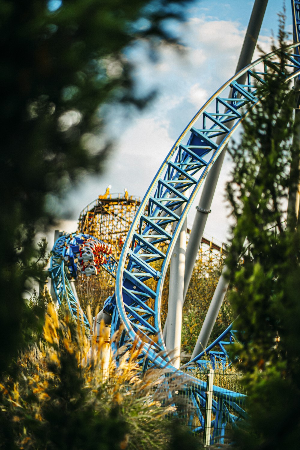 a roller coaster going down a hill in a park