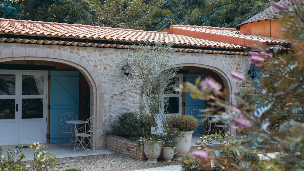 a stone house with a blue door and windows