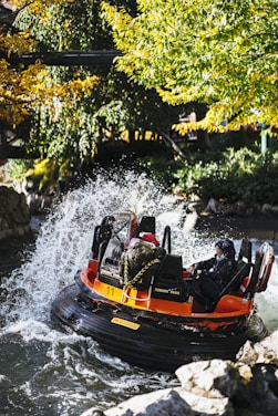 Thrilled adventurers navigating white-water rapids surrounded by dense tropical forest.