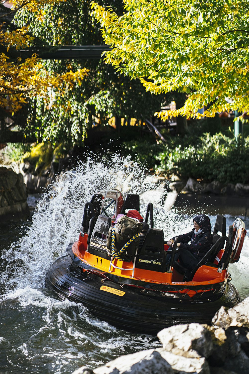 a group of people riding on the back of a raft down a river