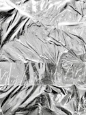 Aluminum sheets reflecting light, highlighting their smooth, clean surfaces.